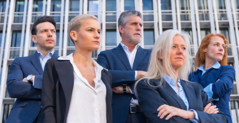 Portrait of Senior Executives in Business Attire in Modern Look Worried in front of Commercial Building